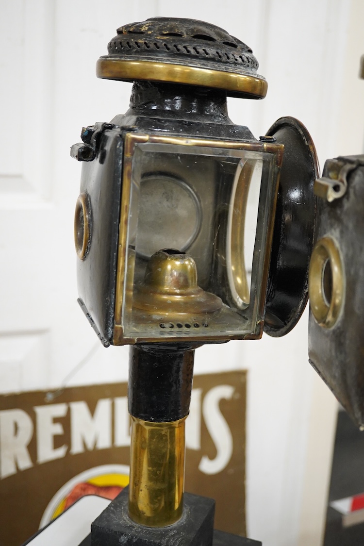 Two 19th century brass and painted steel carriage lamps, one by Raydyot with sprung ‘self adjusting’ candle holders, now mounted on modern painted pine bases for display purposes